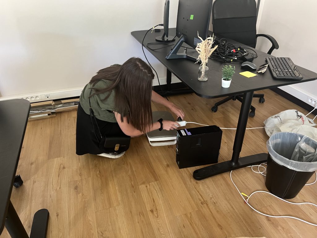 Alexandra installe son matériel informatique en revenant à l'agence